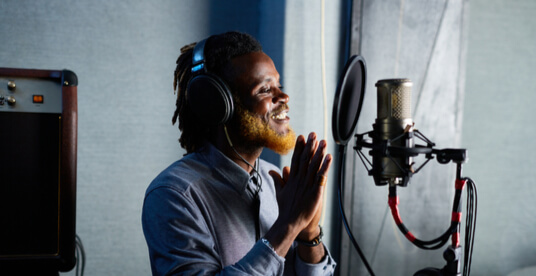 a man recording with headphones on