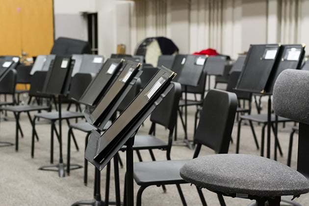 Empty music classroom with seats and sheet stands.